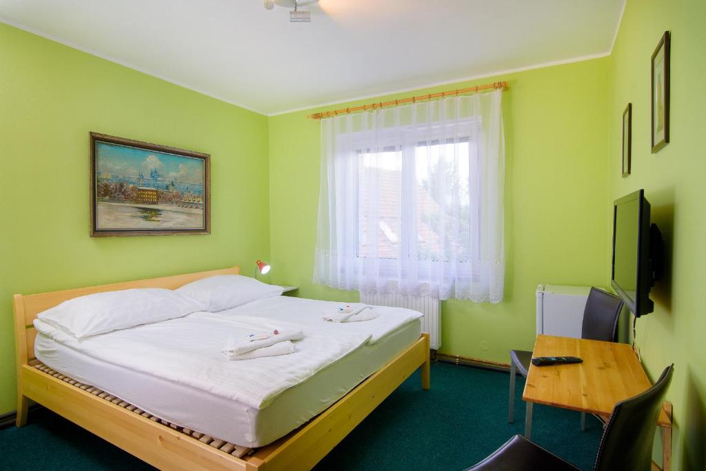 Postel nebo postele na pokoji v ubytování Hotel Max