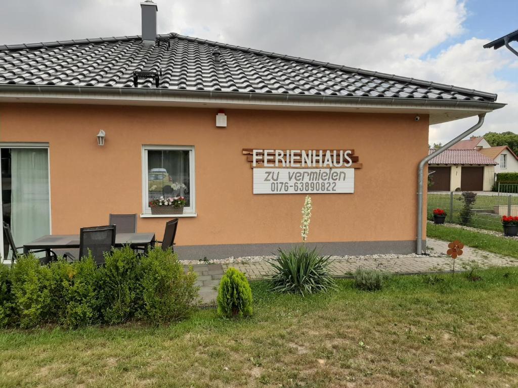 a house with a sign on the side of it at Am Bahnhof in Werneuchen