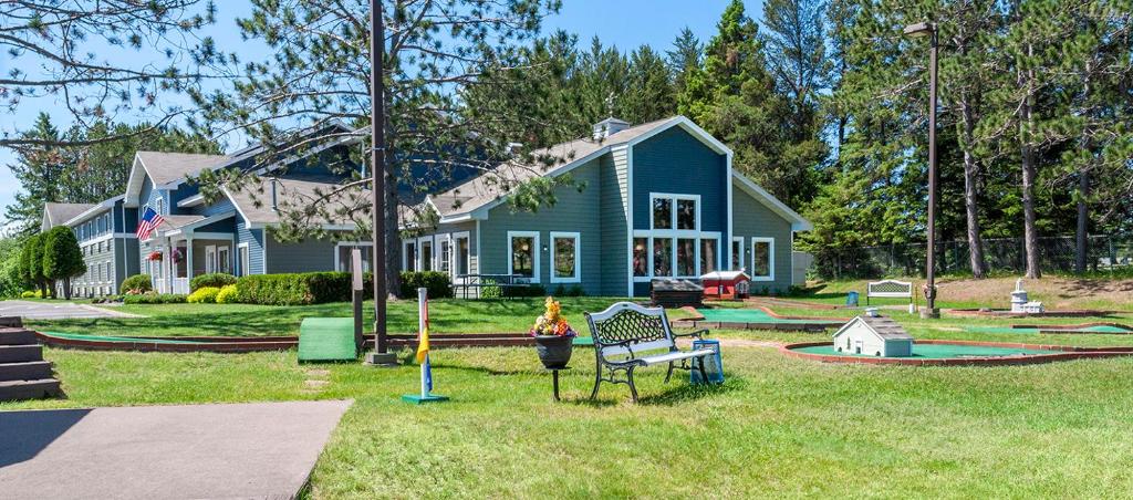 a blue house with a playground in front of it at Country Inn Two Harbors in Two Harbors