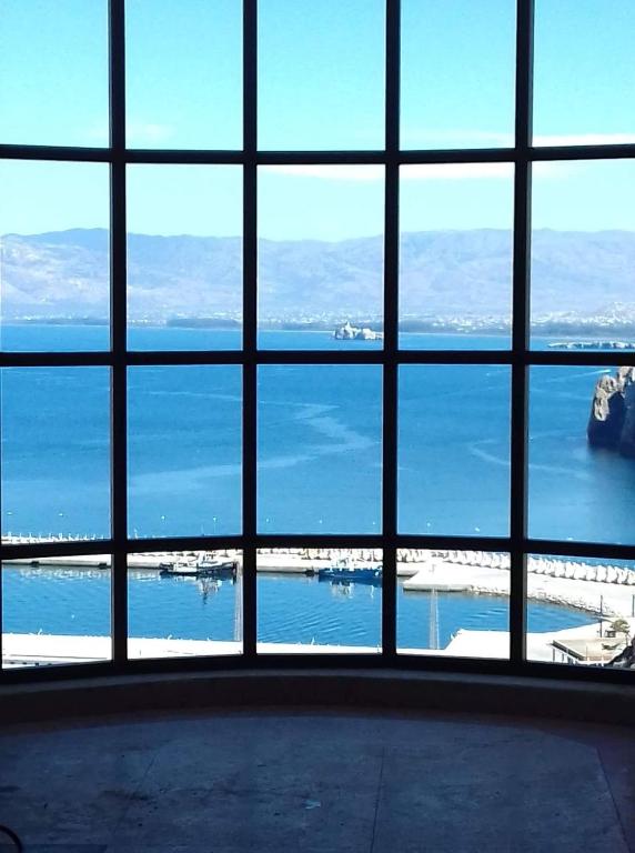 a view of the ocean from a large window at Al-marsa2 in Al Hoceïma