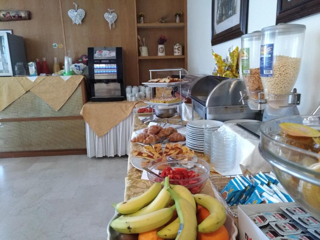 a buffet with bananas and other fruit on a counter at Hotel Tiziana in Rimini