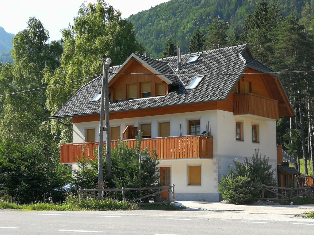 a large house with a gambrel roof at Apartmaji Lajf in Kranjska Gora