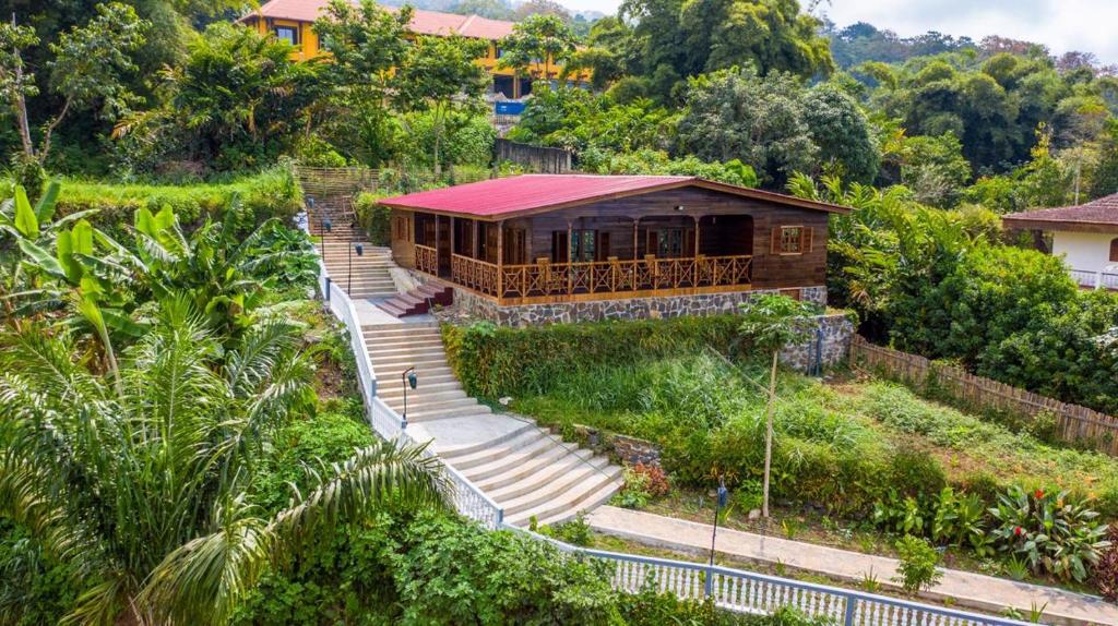 a house with stairs leading up to it at Roça Saudade Guest House in Trindade