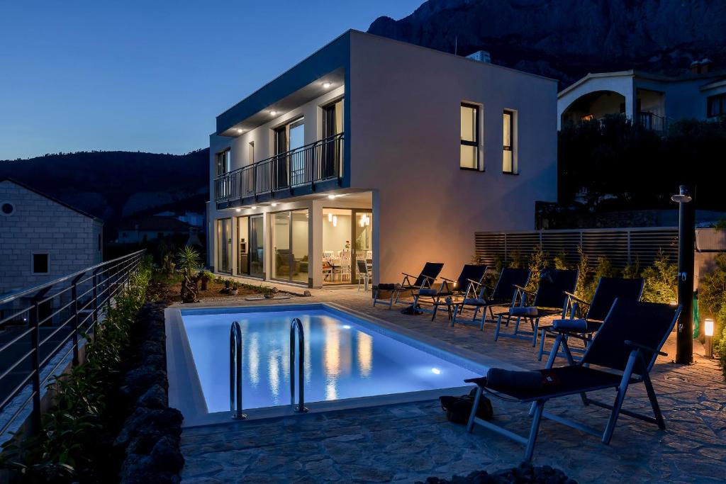a house with a swimming pool in front of a house at Villa Smart in Veliko Brdo