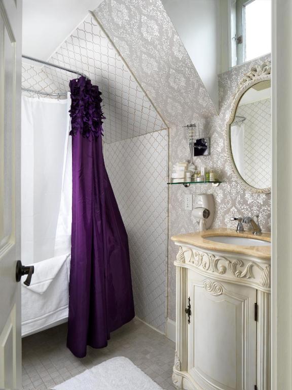 a bathroom with a purple shower curtain and a sink at Pendray Inn and Tea House in Victoria