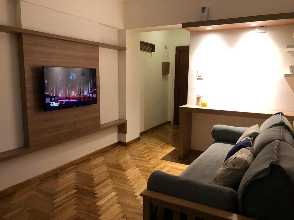 sala de estar con sofá y TV de pantalla plana en Departamento temporal Colon 401 en Córdoba