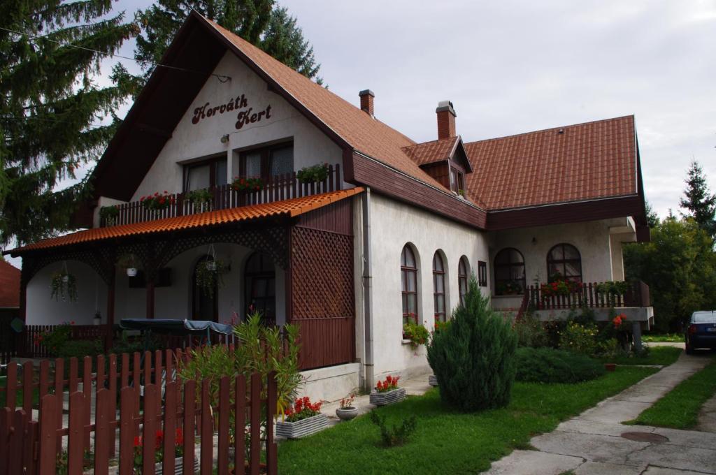 a house with a fence in front of it at Horváth Kert Vendégház in Zirc