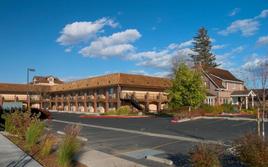 a building with a parking lot in front of it at Carson Valley Motor Lodge and Extended Stay in Minden