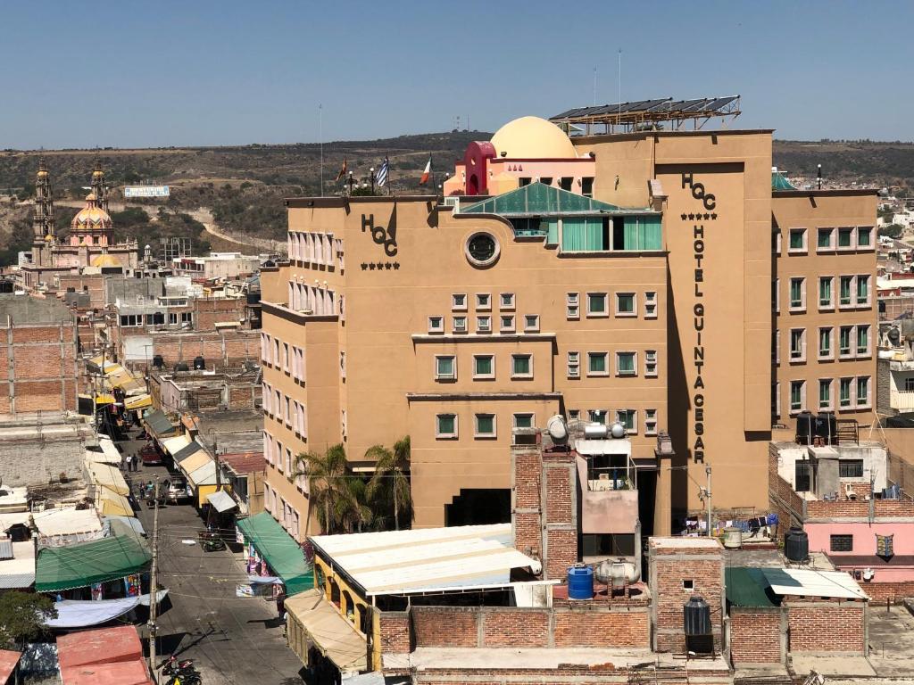 a view of a city with a large building at Hotel Quinta Cesar in San Juan de los Lagos