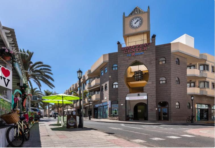 a building with a clock tower on top of it at Casa Sandra in Corralejo