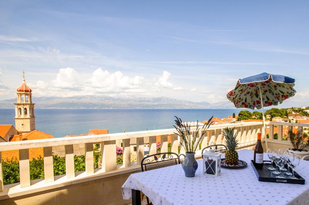 a table on a balcony with a view of the ocean at Great view apartment in Sutivan