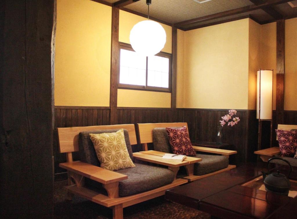 a living room with a couch and a window at K's House Takayama [1st K's Hostel] in Takayama
