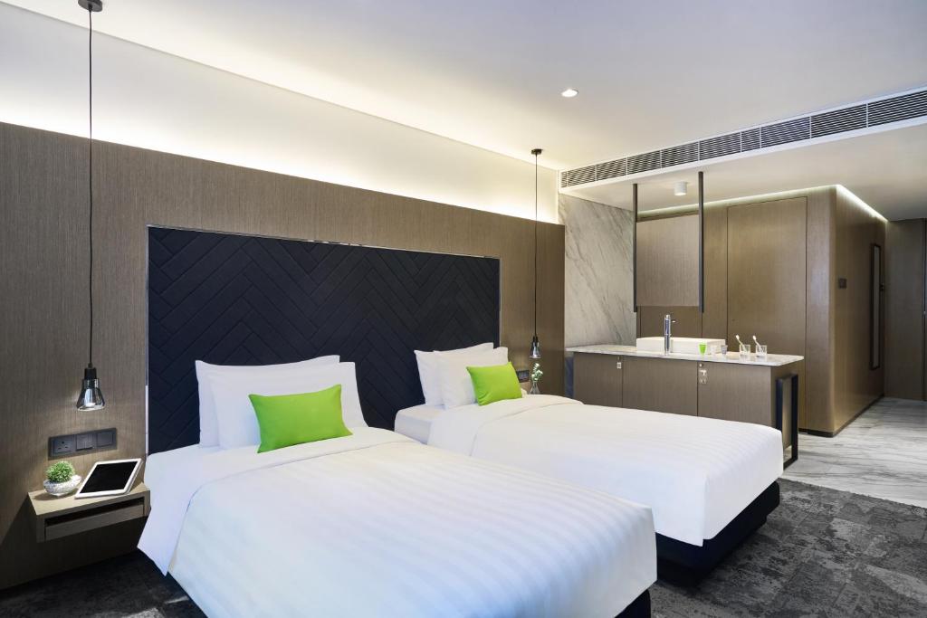 Postel nebo postele na pokoji v ubytování Hotel Ease Tsuen Wan