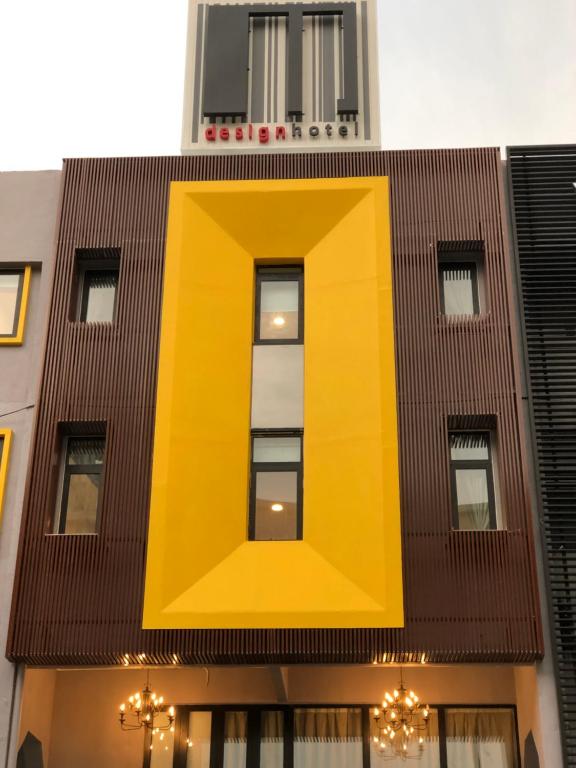 a building with a large yellow rectangle on it at M Design Hotel @ Taman Pertama in Kuala Lumpur