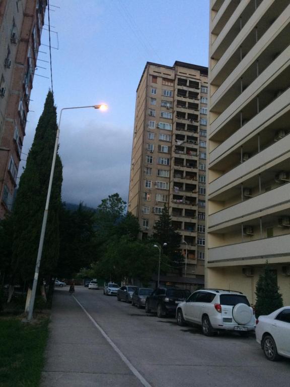 a street light in a parking lot next to buildings at Apartment in Gagra in Gagra