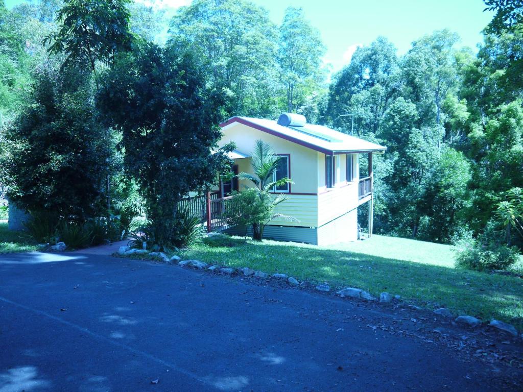 a small house in the middle of a driveway at Teretre Cabins Nimbin in Nimbin