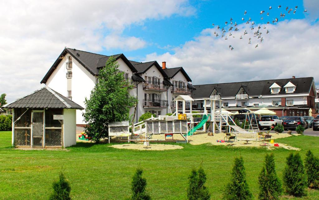a large house with a playground in front of it at Ośrodek Wczasowy REWA in Rewa