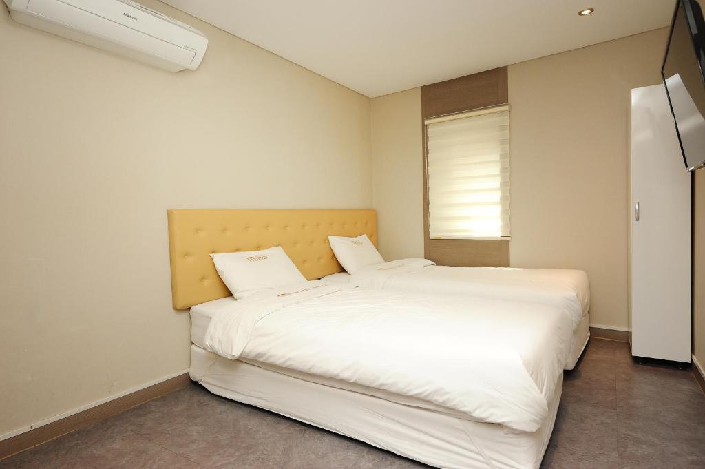 Postel nebo postele na pokoji v ubytování Hotel MIDO Myeongdong