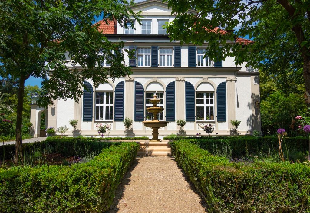 a house with a fountain in front of it at Villa Golding - Flat 2 in Dresden