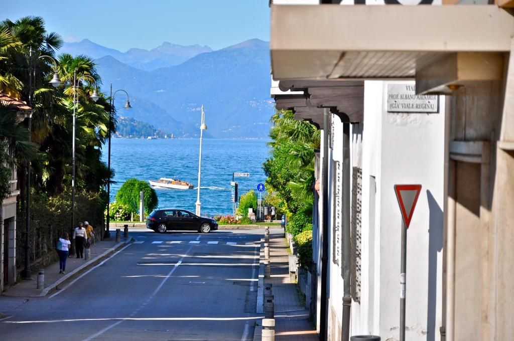 a street with a car parked on the side of the road at Hotel Boston in Stresa
