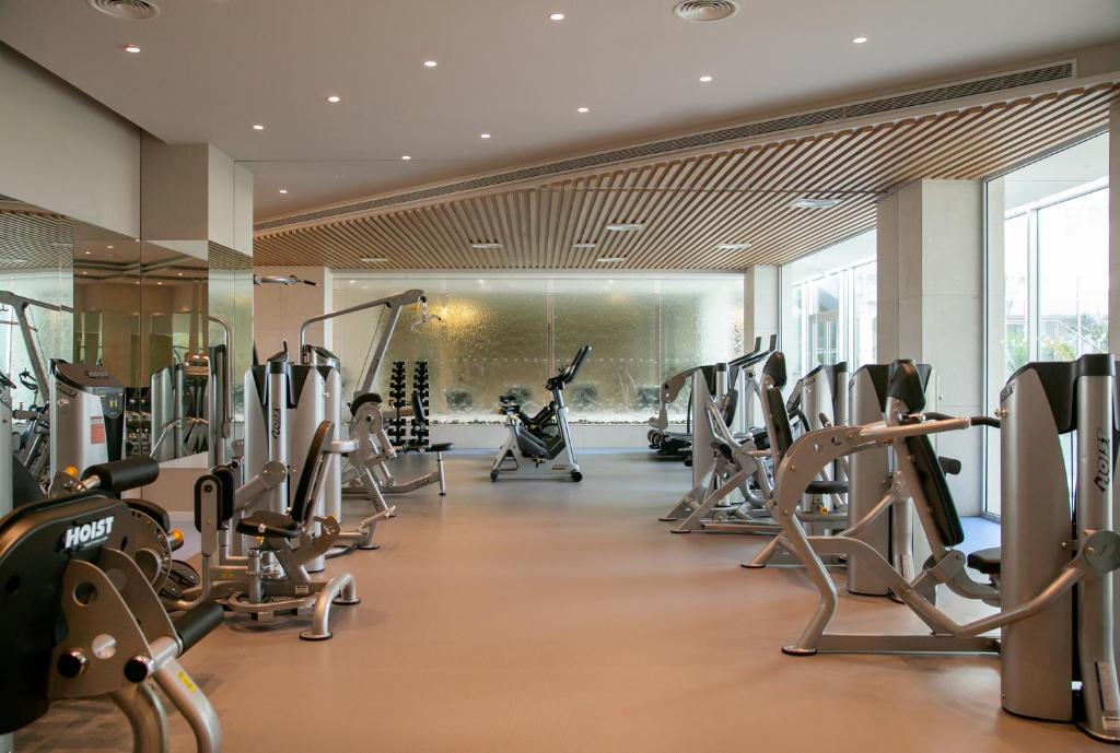 a gym with treadmills and elliptical machines at NissiBlu Beach Resort in Ayia Napa