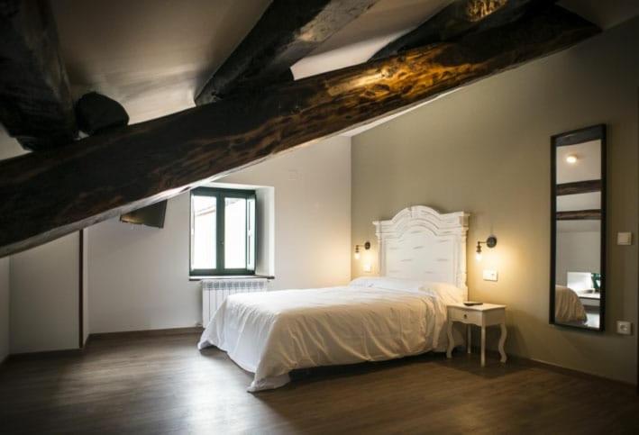 a bedroom with a white bed and a window at Hotel portico in Fonsagrada