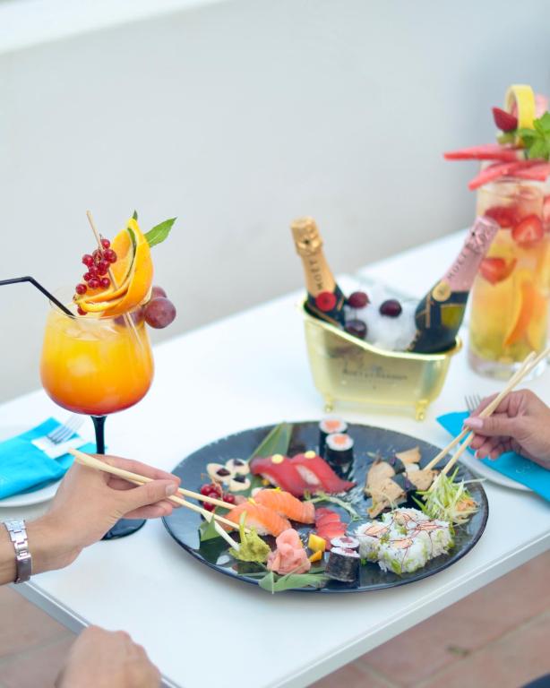 a table with a plate of food and a drink at Gran Hotel Guadalpín Banus in Marbella