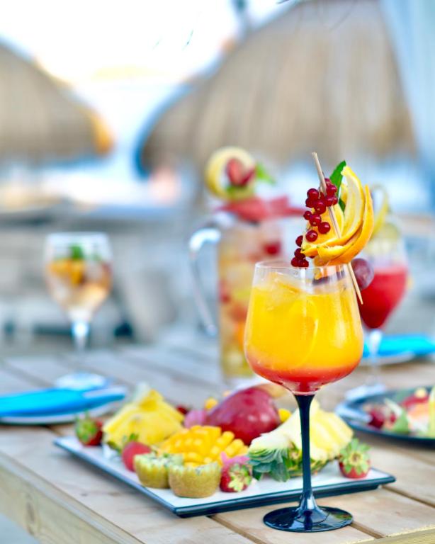 a drink on a table with a plate of food at Gran Hotel Guadalpín Banus in Marbella
