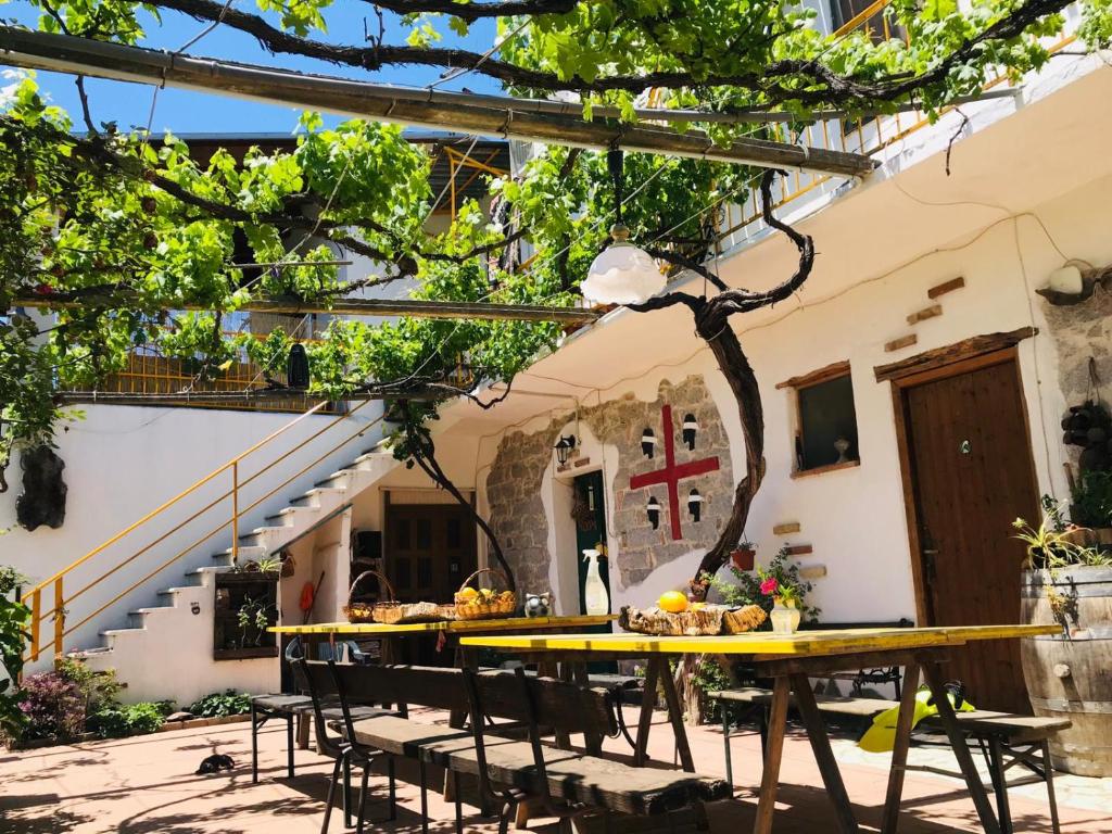 a table and chairs in front of a building at S'Imbragu Farm B&B in Tortolì