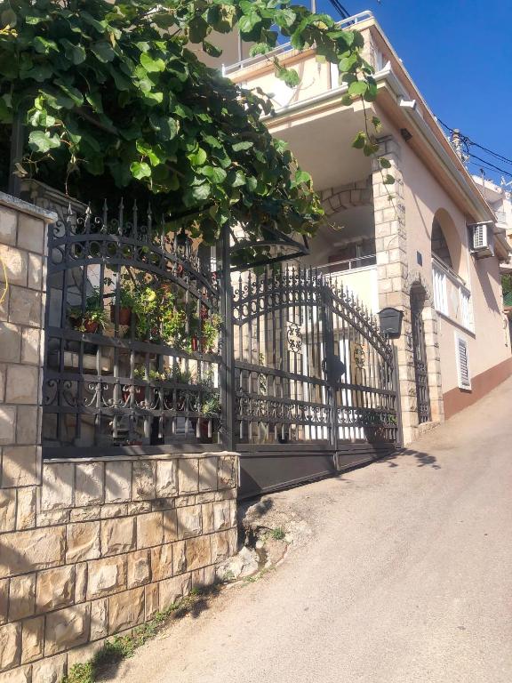 a wrought iron fence in front of a house at Apartments Moracanin in Sutomore