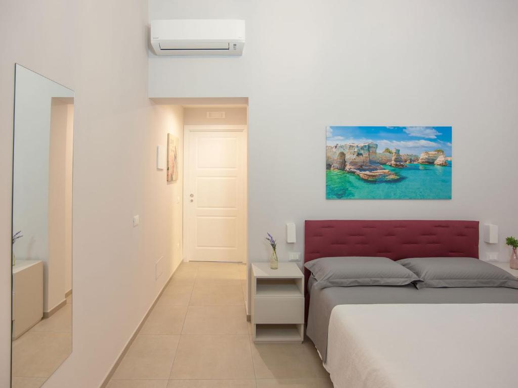 a bedroom with a bed and a painting on the wall at Campanili di Puglia B&B in Andria