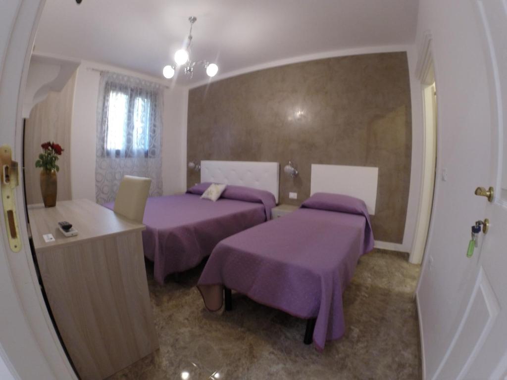Postel nebo postele na pokoji v ubytování B&B Nonna Teresa
