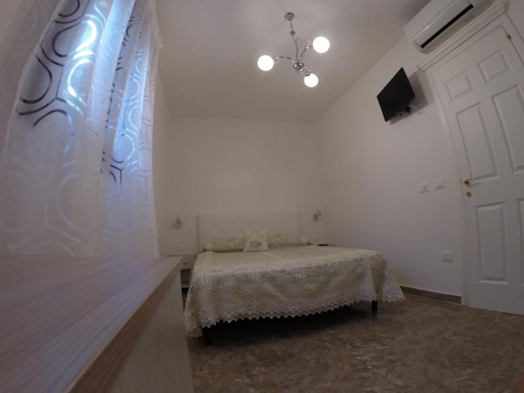 Postel nebo postele na pokoji v ubytování B&B Nonna Teresa
