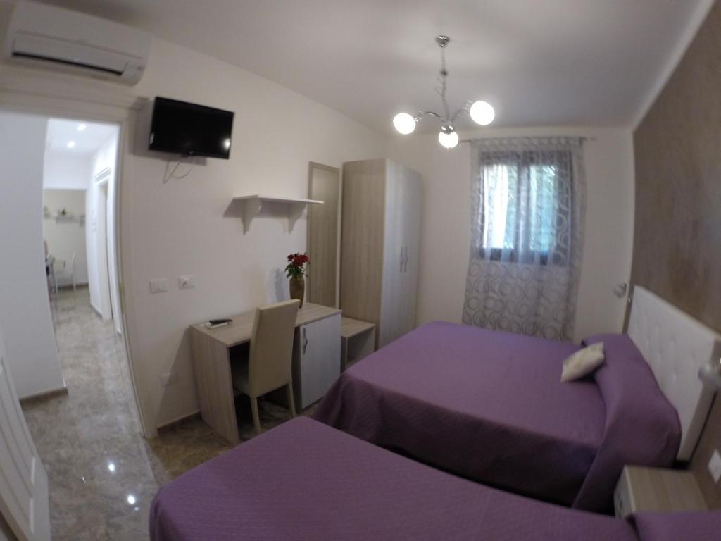 Postel nebo postele na pokoji v ubytování B&B Nonna Teresa
