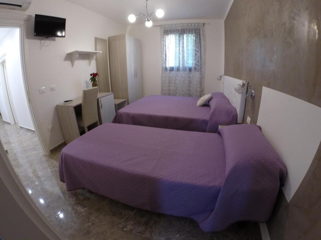 Postel nebo postele na pokoji v ubytování B&B Nonna Teresa