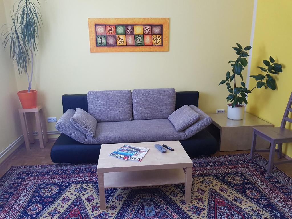 a living room with a couch and a coffee table at Garden Apartment Donau-City (P&R) in Vienna