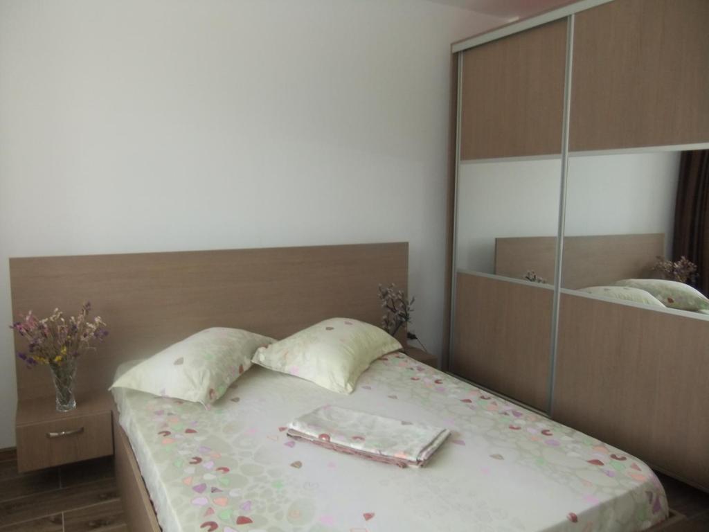 a bedroom with a bed with a large mirror at APARTAMENT REBEKA in Mamaia Nord