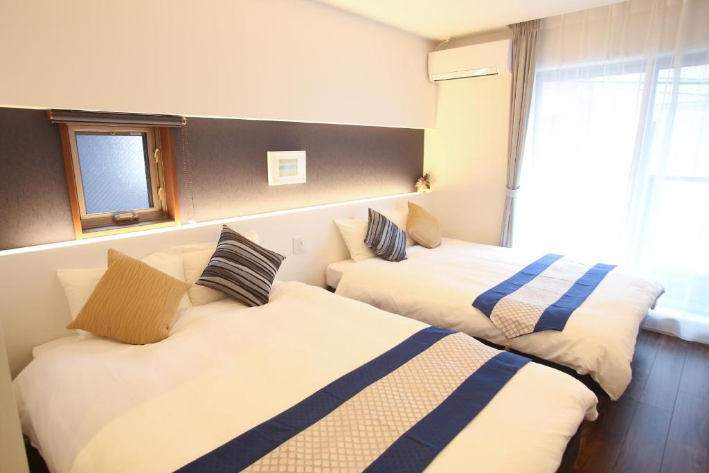 Postel nebo postele na pokoji v ubytování Apartment Hotel Tenjin TUMUGU