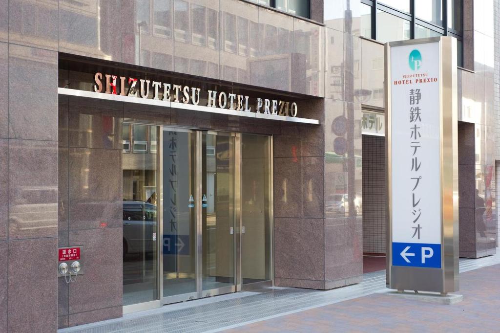a building with a sign in front of it at Shizutetsu Hotel Prezio Shizuoka Ekinan in Shizuoka