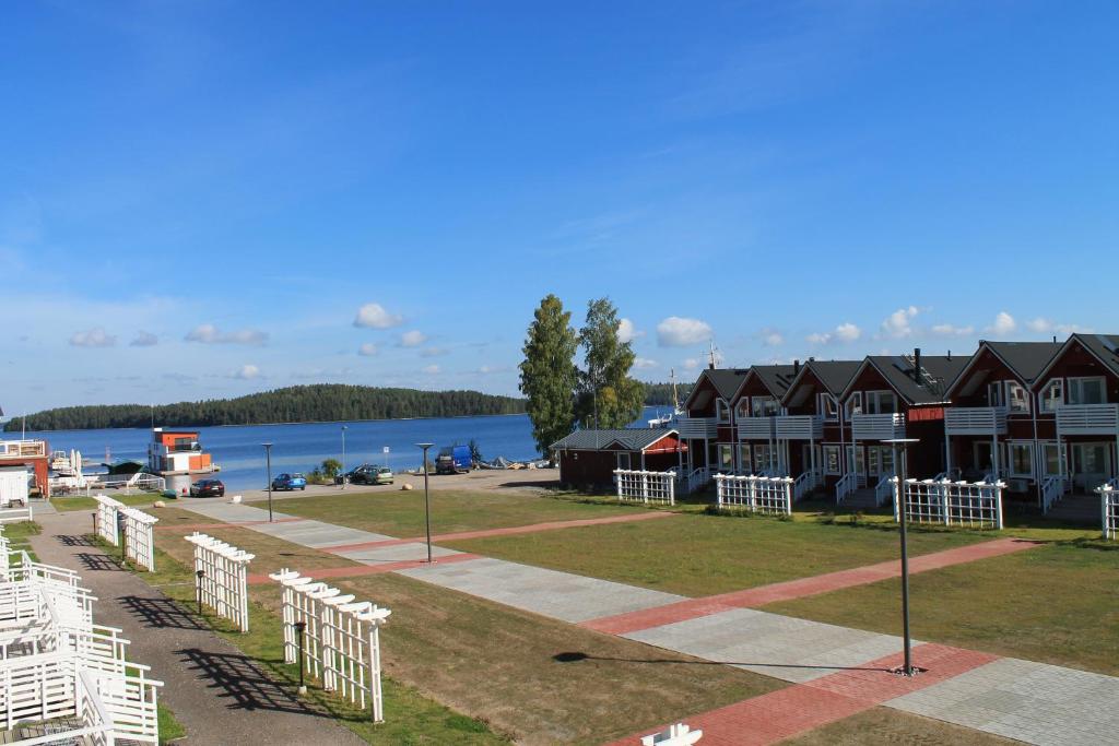 a row of houses on the shore of a body of water at SResort Marina Villas in Imatra