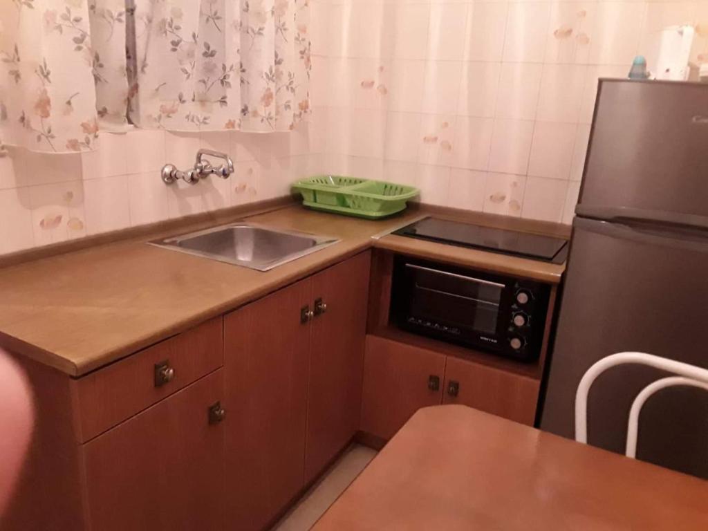 a small kitchen with a sink and a refrigerator at ARTEMIS Studios & Apartments Sidari in Sidari