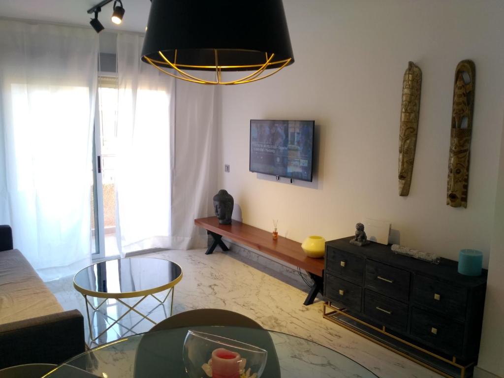 A television and/or entertainment centre at Apartamento Puertoplaya II