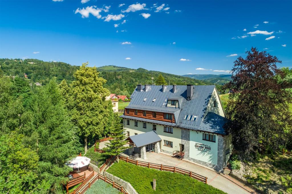 an aerial view of a house in the mountains at Centrum Green Hill Business & SPA in Wisła