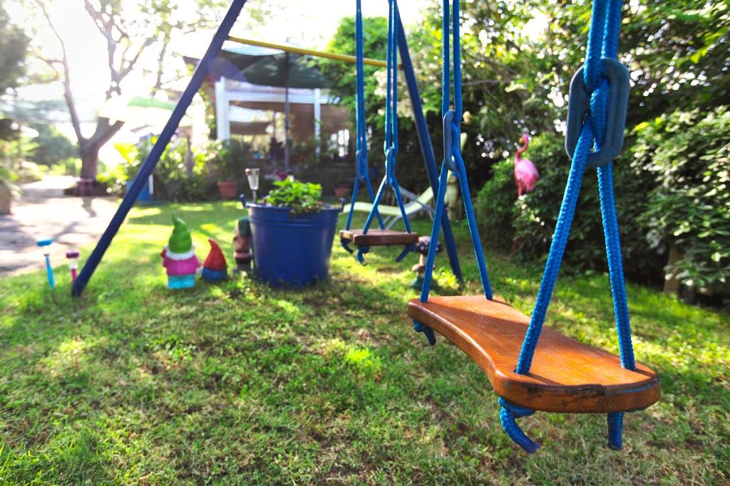 a swing in a yard with some toys on the grass at Apartments Baredi in Izola