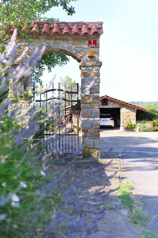 a stone archway with a gate in front of a building at Apartments Baredi in Izola
