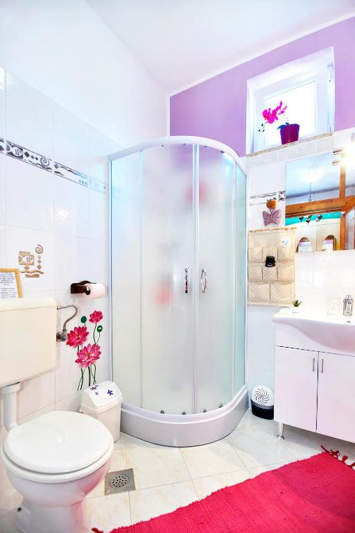 a bathroom with a shower and a toilet and a sink at Apartments Baredi in Izola
