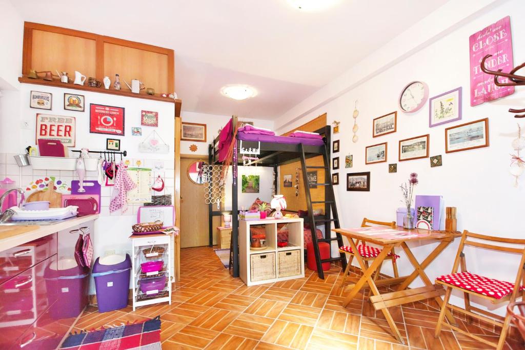 a kitchen and dining room with a table and chairs at Apartments Baredi in Izola