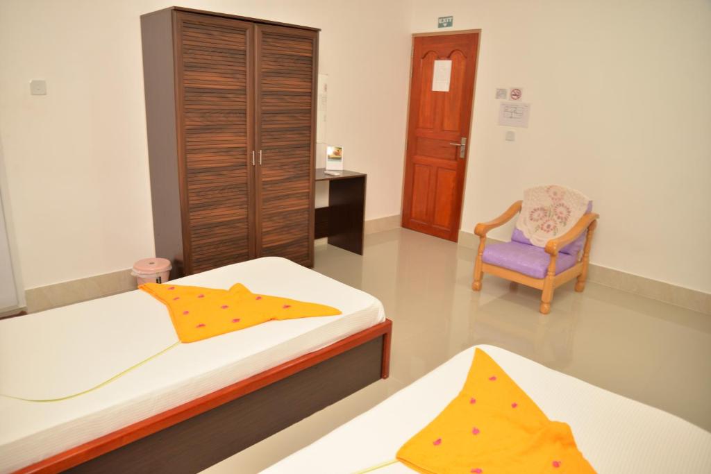 Postel nebo postele na pokoji v ubytování Moodhumaa Inn