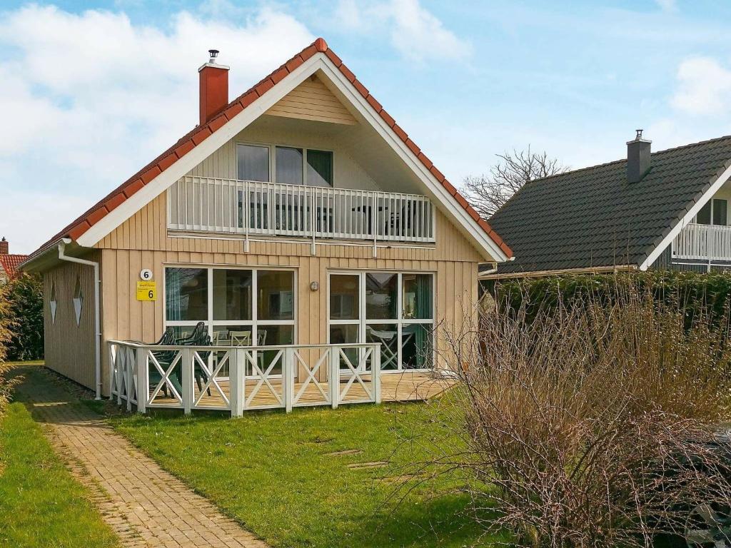 a house with a large porch and a balcony at 8 person holiday home in Gelting in Gelting