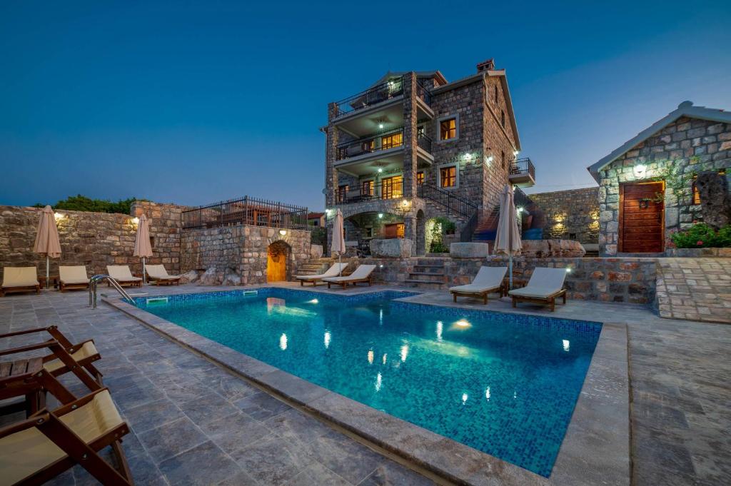 una casa con piscina frente a un edificio en Villa Old Castle Apartments, en Kotor